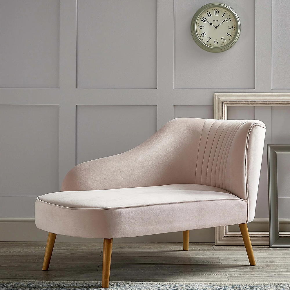 room with wooden flooring and pink chair