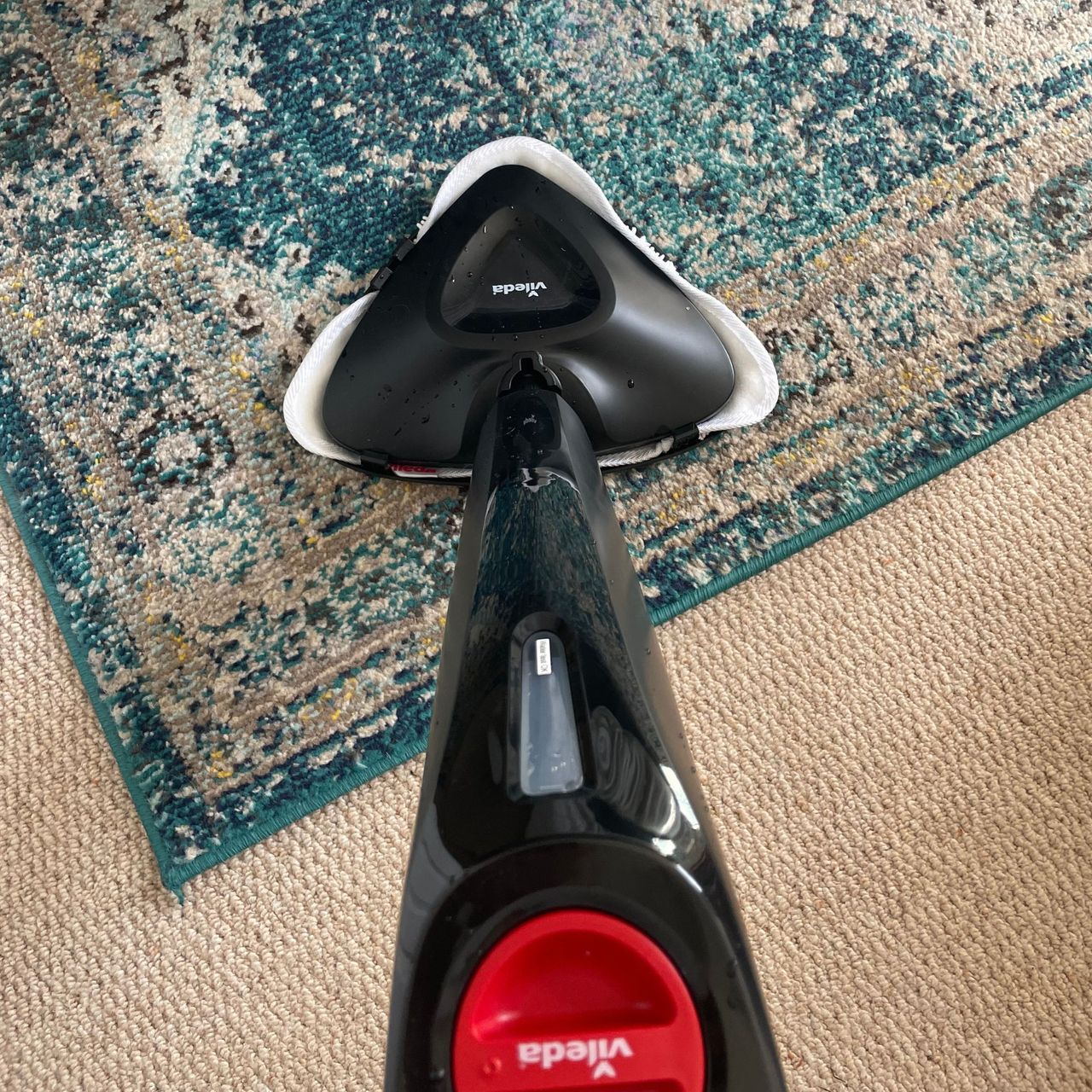 Using the Vileda Steam Mop Plus on a blue rug on cream carpet