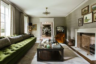 a green-toned living room with green velvet chesterfield sofa