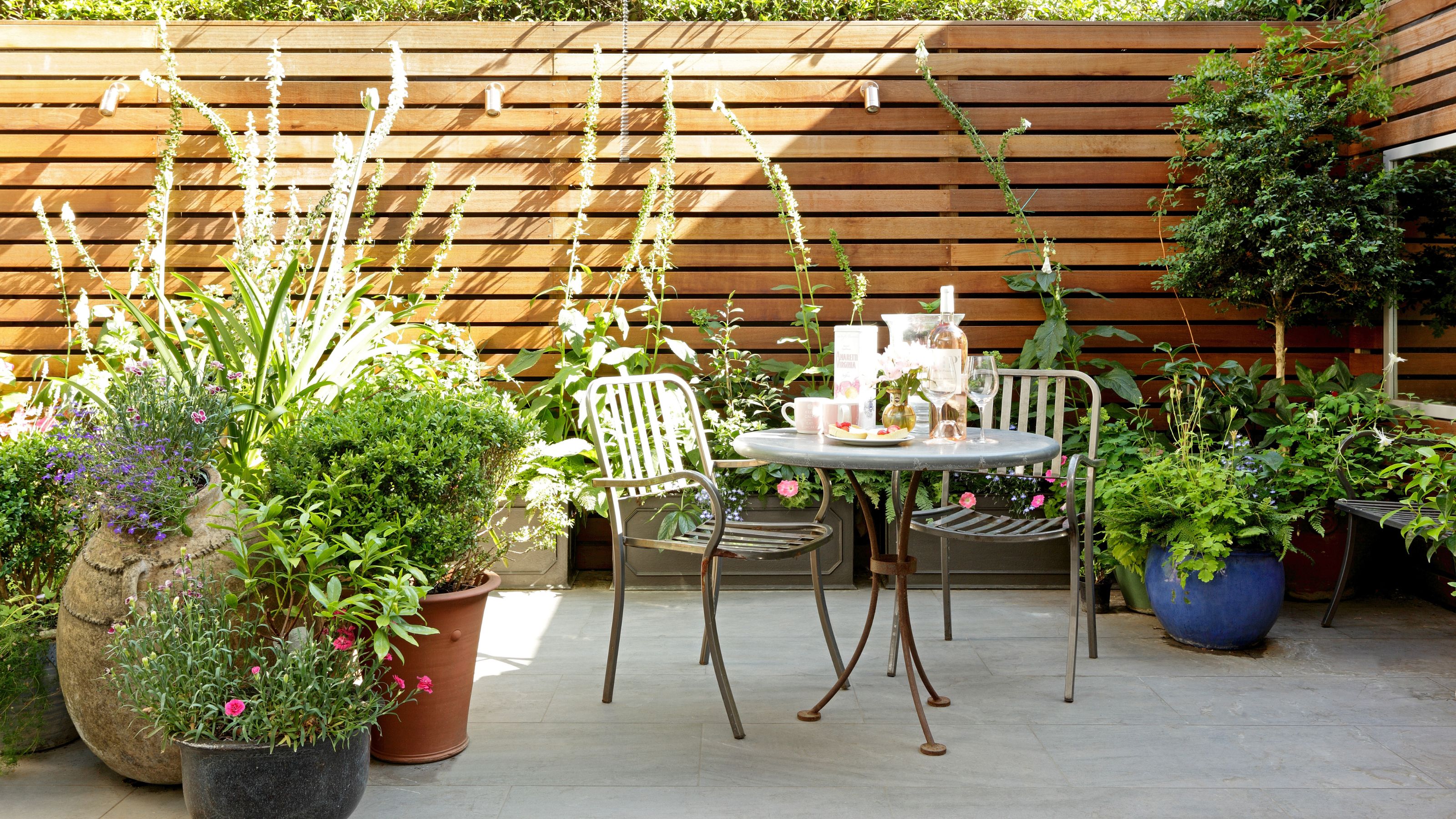Small patio with a patio set and plants on it