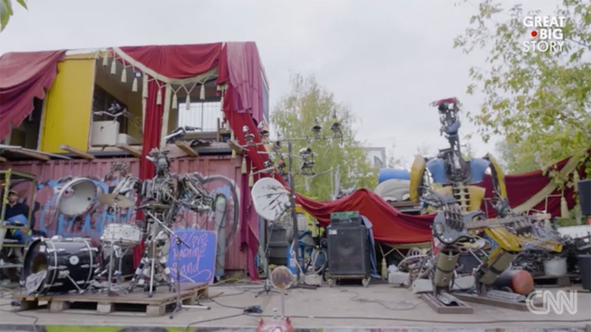 A punk band made of robots play drums and bass guitar