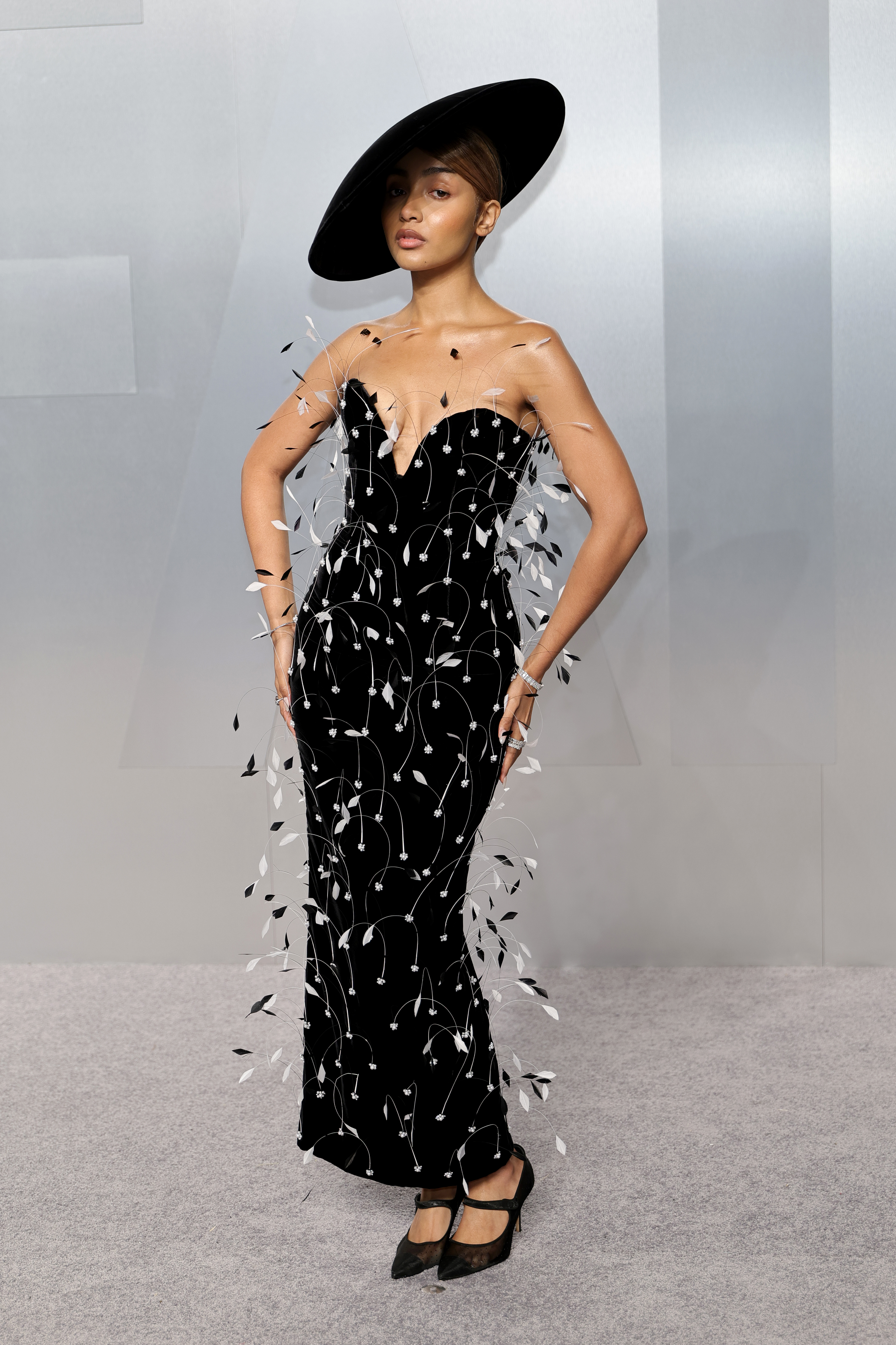 Pink Pantheress attends the Oscars after-party wearing a black-and-white feathered dress.