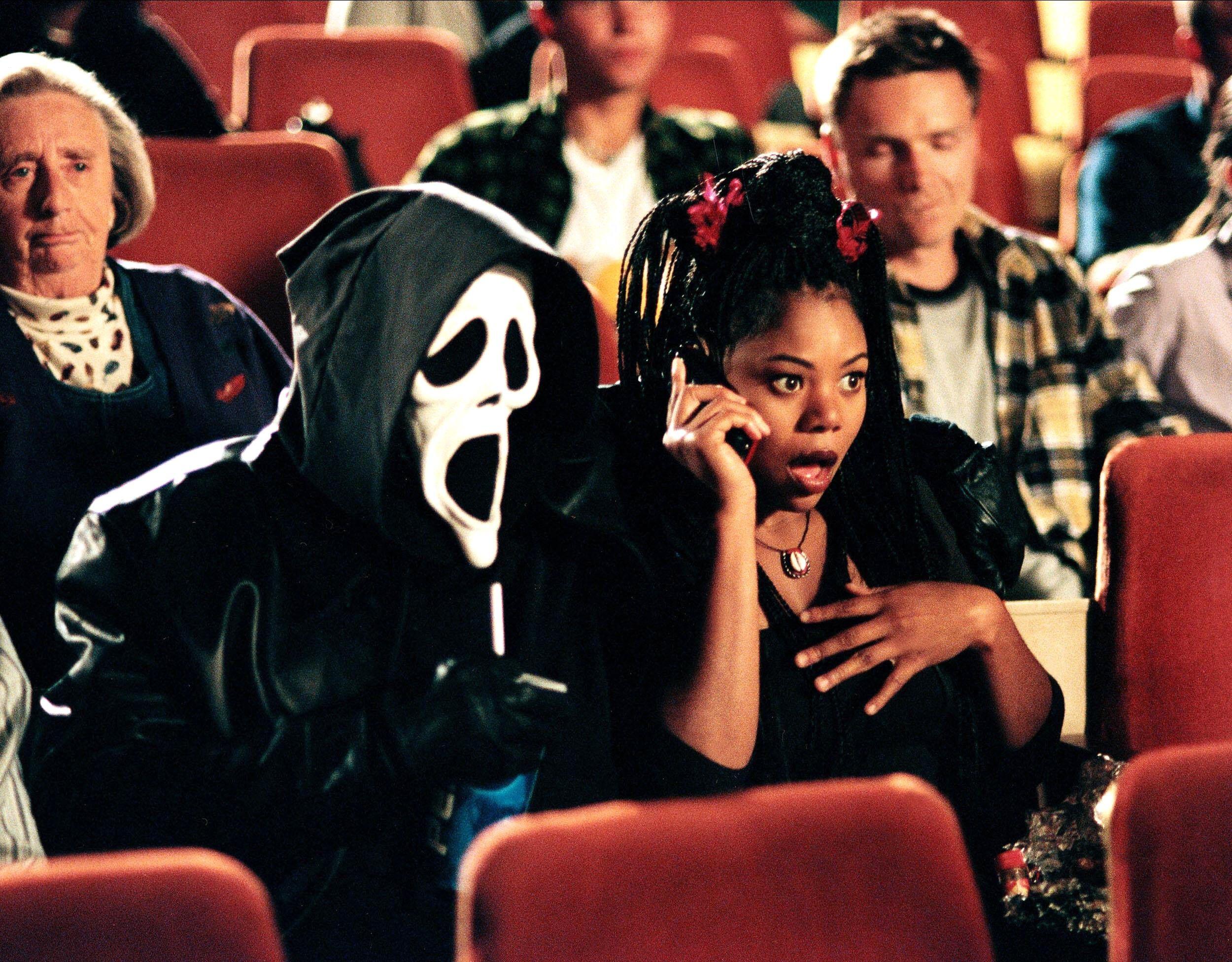 regina hall and ghostface in a movie theater in scary movie 2000