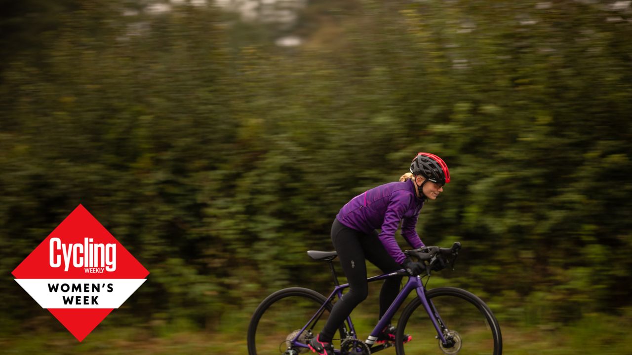 Image shows a small adult cyclist riding a bike