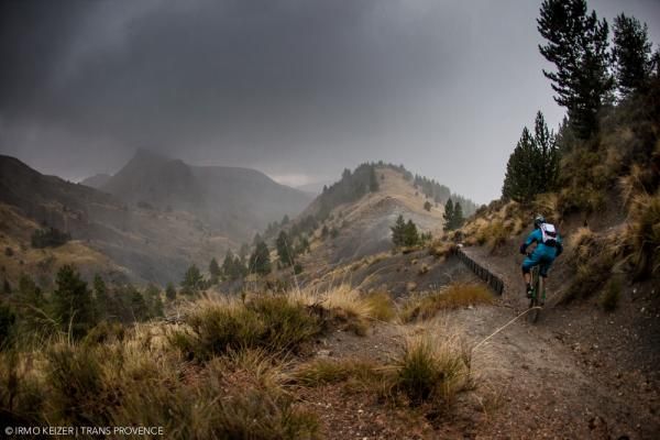 A racer high up in the mountains in a storm.