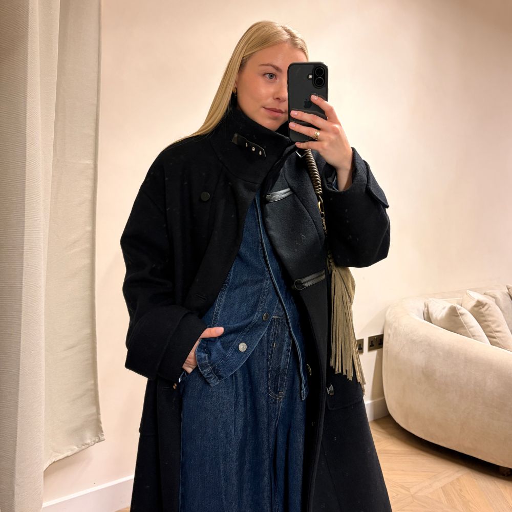 Florrie wears a black coat, denim shirt and denim jeans from the M&amp;S runway collection