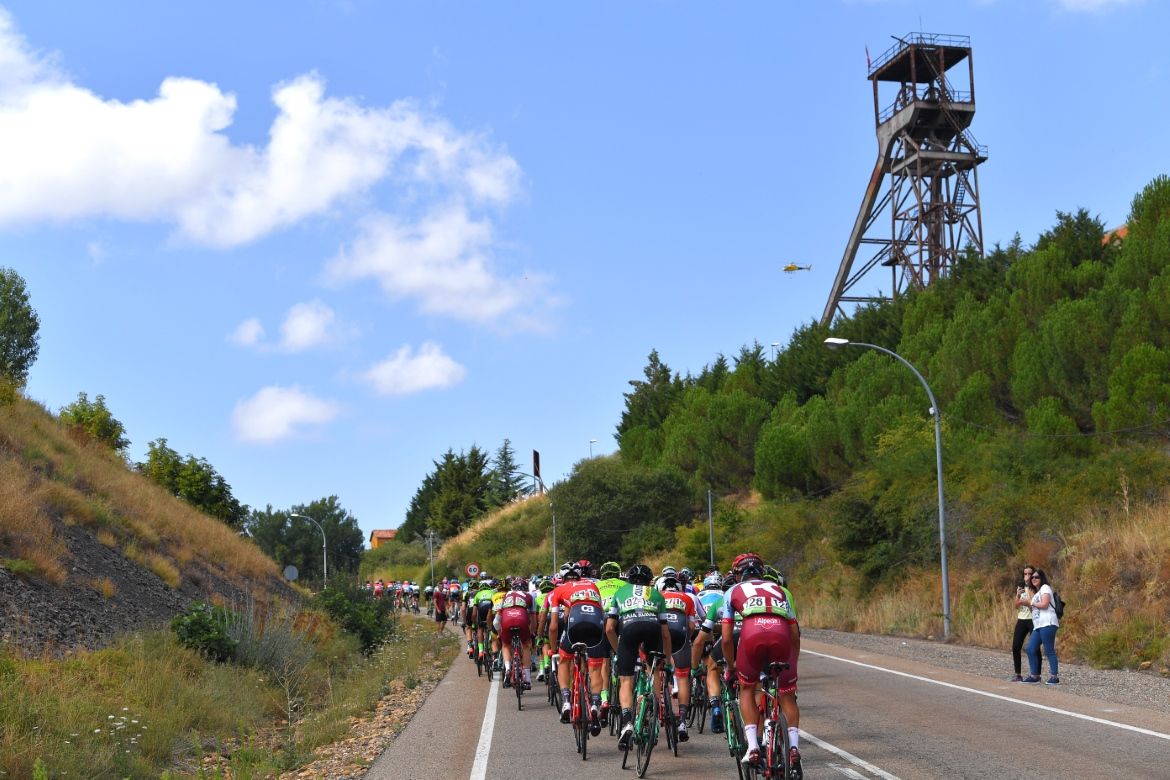 The peloton passes one of the many mines in Asturias