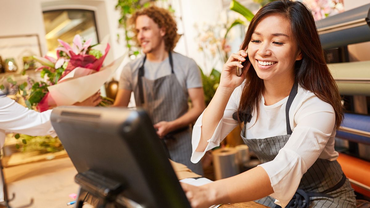 Woman placing a customer order in a shop