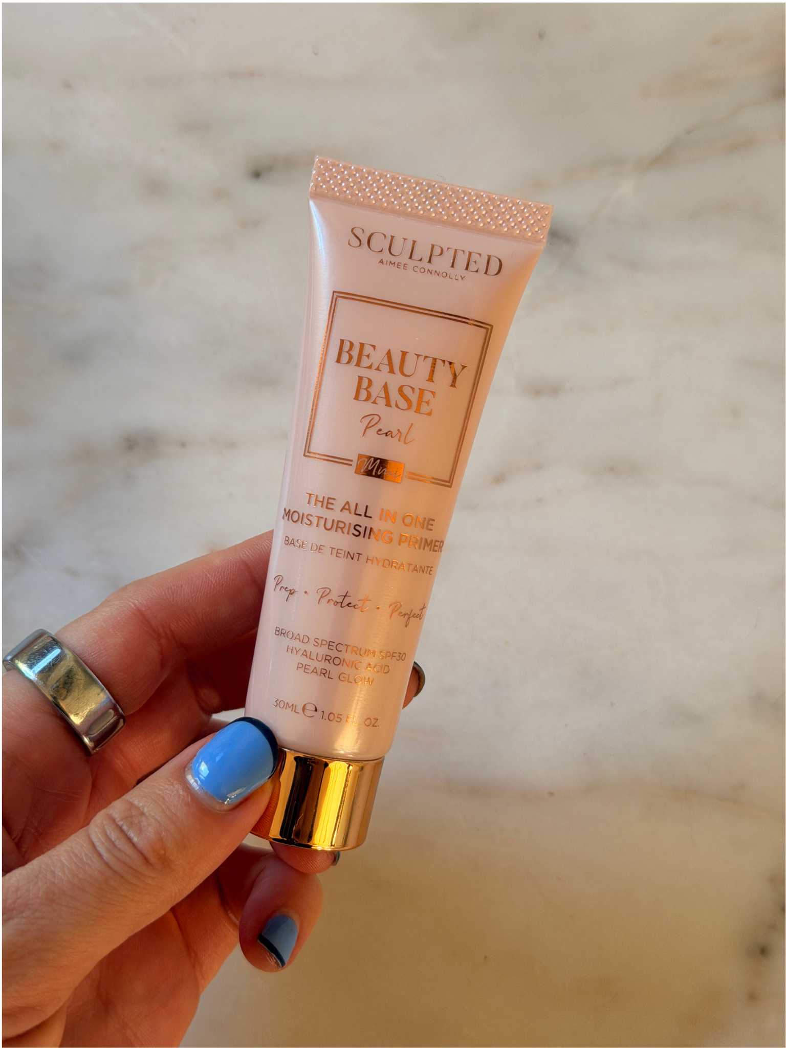 Freelance beauty editor Grace Day holding the Sculpted By Aimee primer.
