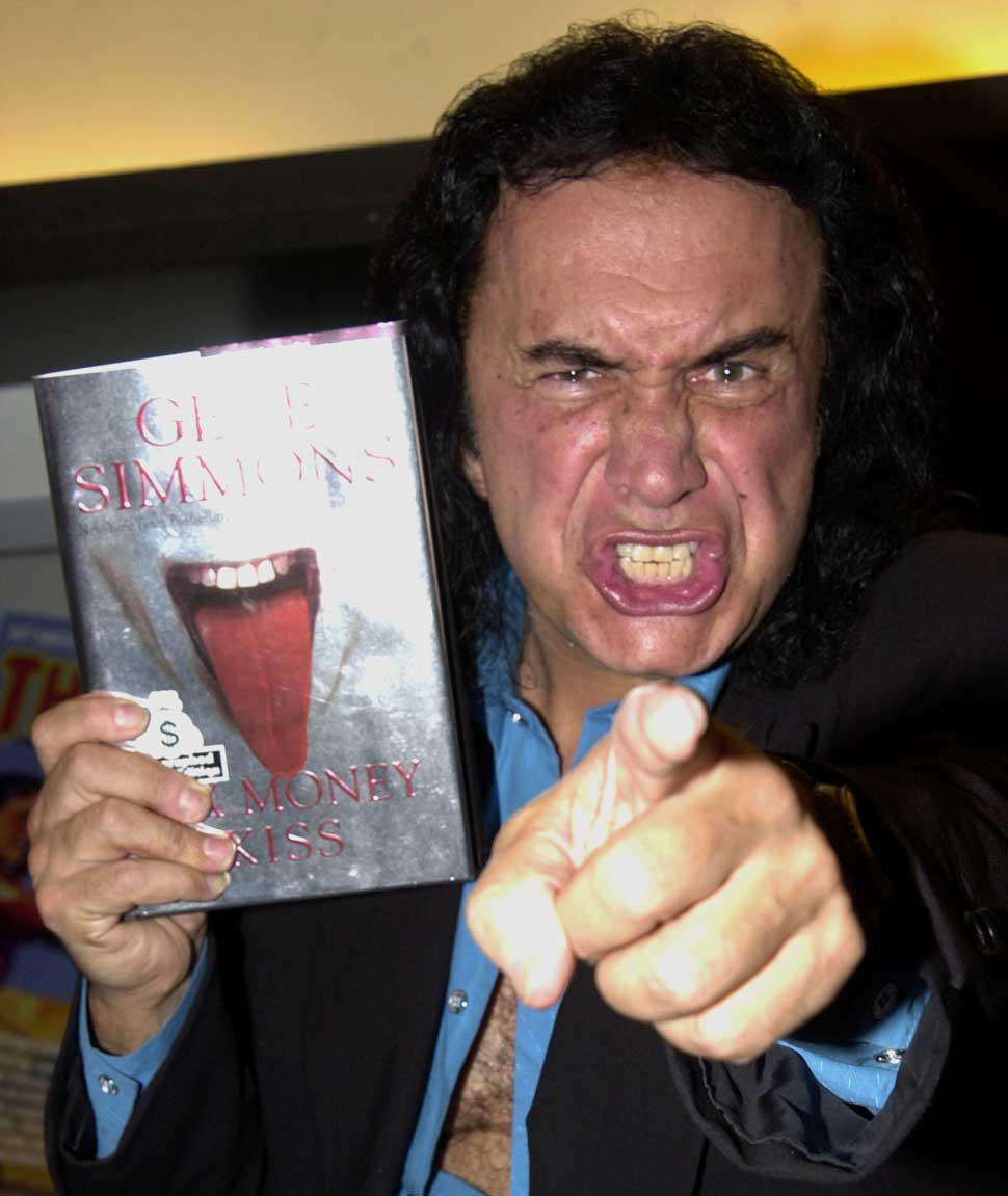 Gene Simmons with a copy of his book, Sex Money Kiss