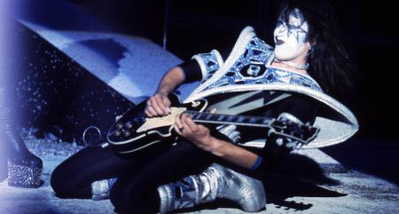 Ace Frehley falls to his knees as he plays his Les Paul onstage as Kiss's Spaceman.