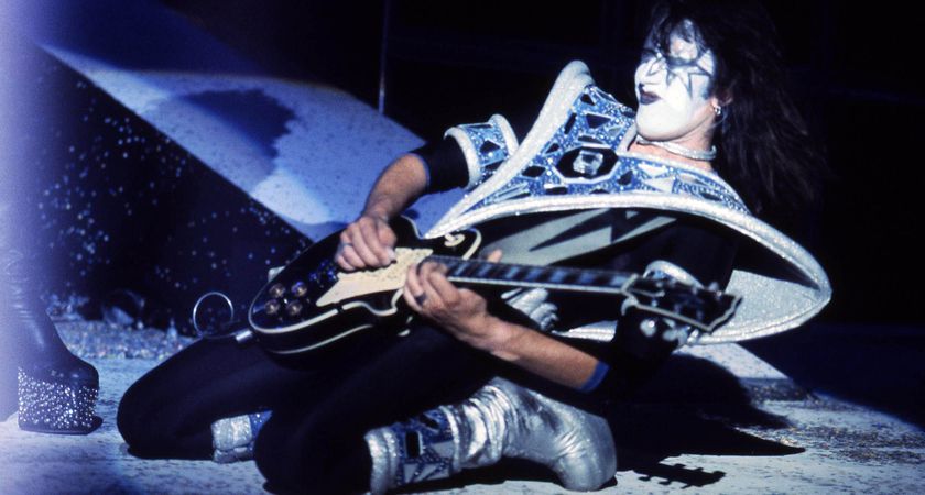 Ace Frehley falls to his knees as he plays his Les Paul onstage as Kiss's Spaceman.