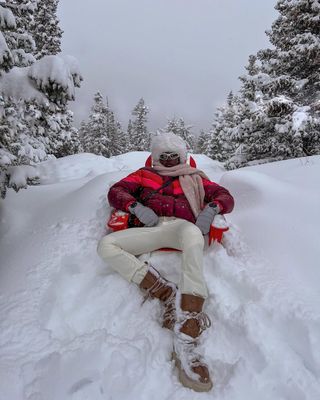 Lefevre diary in snow boots, white ski trousers and wrap-around sunglasses