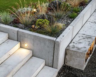 concrete steps and raised bed with recessed lighting