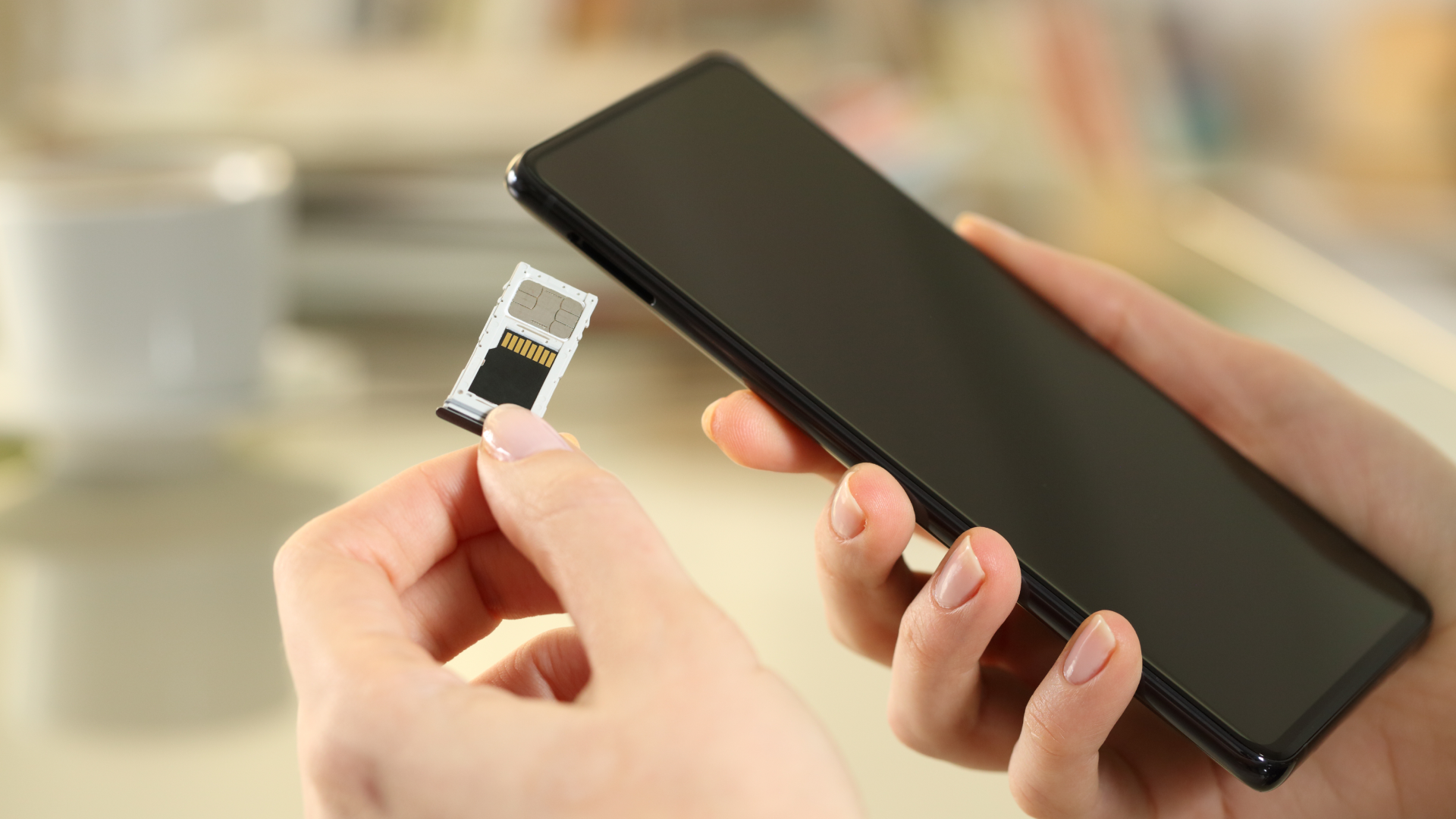 Person removing SIM card from phone