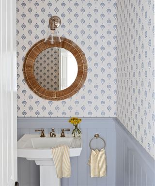 Blue and white bathroom with subtle wallpaper