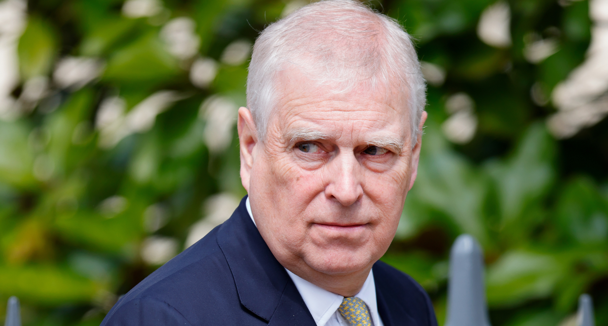 Andrew Mountbatten-Windsor wearing a suit and tie and scowling