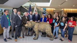 Governor Gavin Newsom signs legislation to strengthen worker protections with legislators, labor leaders, and workers