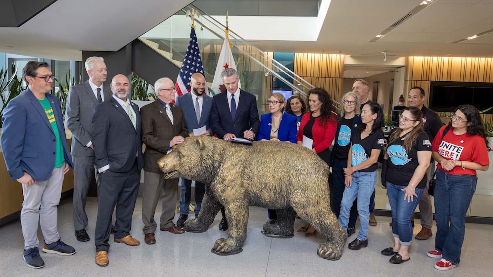 Governor Gavin Newsom signs legislation to strengthen worker protections with legislators, labor leaders, and workers