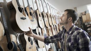 Man shopping for acoustic guitars