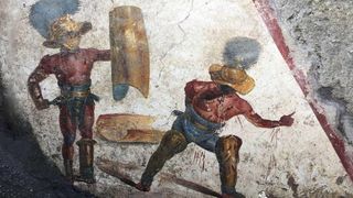 Two gladiators at the end of a fight — one victorious and the other yielding in defeat — appear on the latest fresco found in Pompeii. 