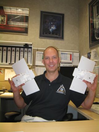 Man with a mission…to the moon. Stuart Spath, chief engineer for NASA’s Gravity Recovery and Interior Laboratory (GRAIL) at Lockheed Martin Space Systems, holds small models of the GRAIL twosome.