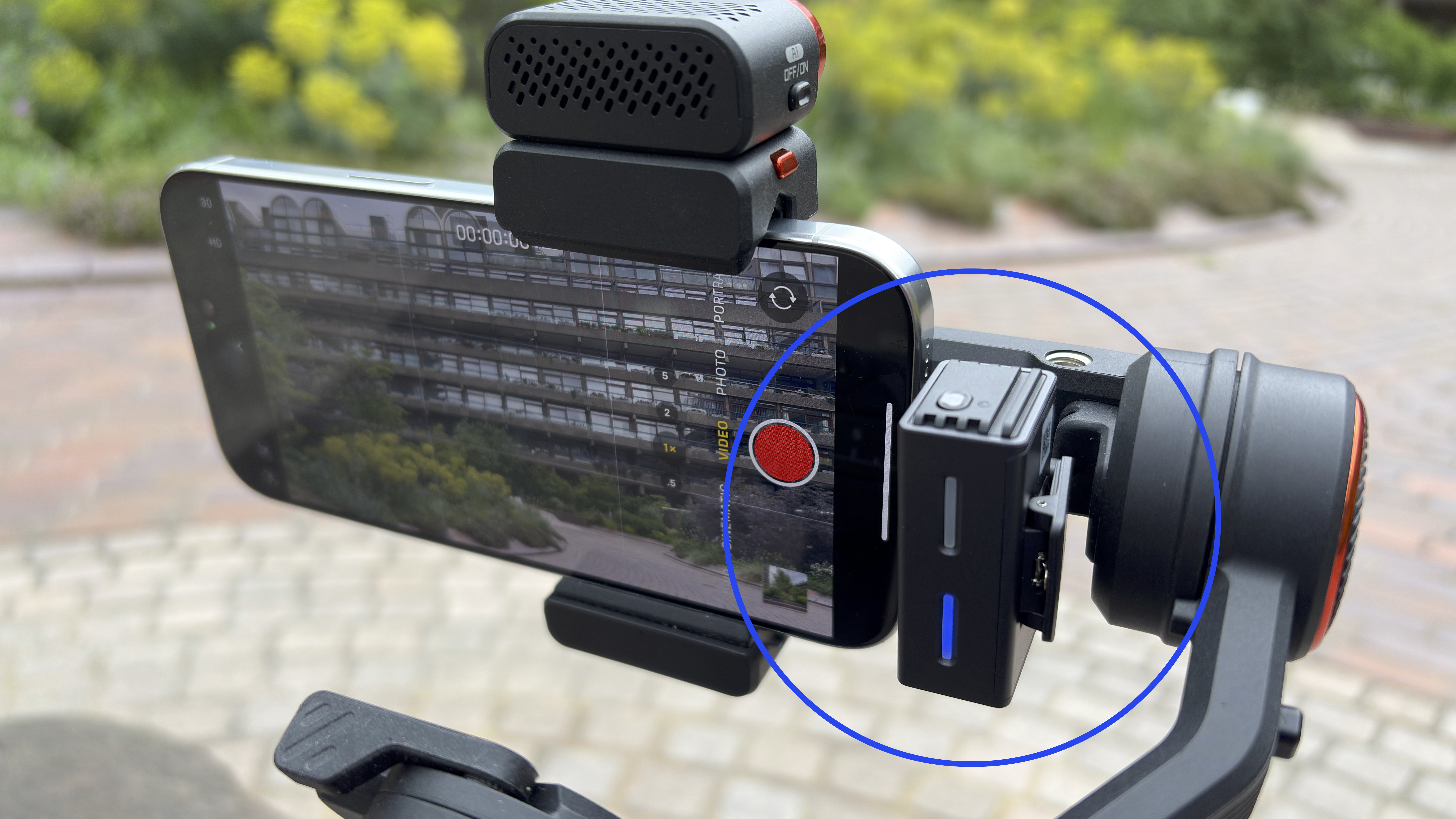 Shot of the Boyalink 3’s receiver plugged int a gimbal-mounted iPhone 16 Pro