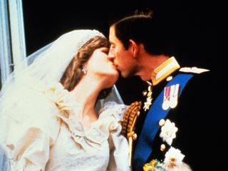 Prince Charles and Princess Diana kiss on the balcony of Buckingham Palace following their wedding