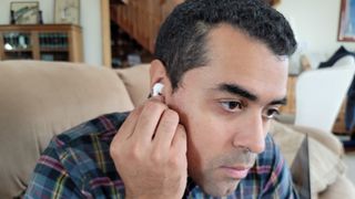 Our reviewer enabling the AirPods 3's transparency mode