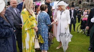 Queen Camilla greets guests during a Garden Party