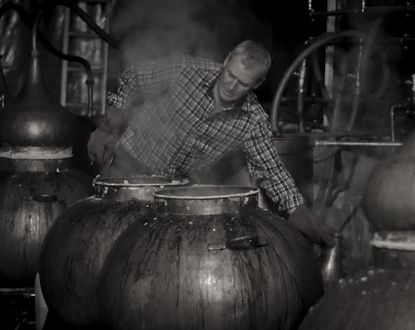 Dr John Walters hard at work distilling.