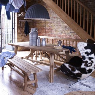 room with cowhide armchair wooden bench and table