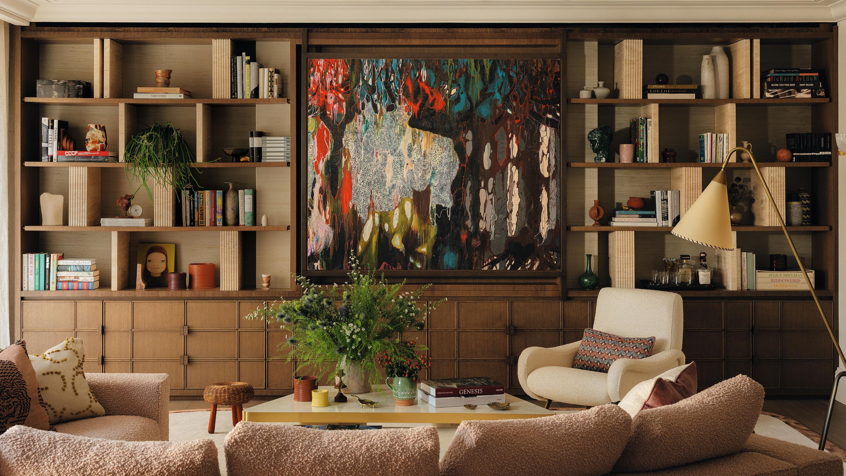 a layered living with a large wooden media wall and abstract artwork hiding the TV