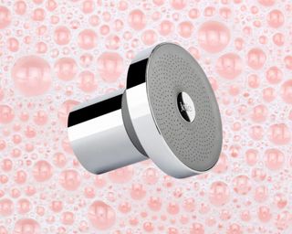 A silver Jolie Shower Head on a pink bubbly background.