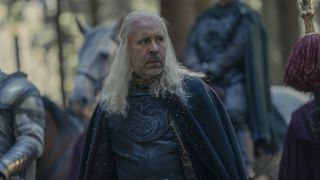 Paddy Considine as King Viserys walking through the woods in House of the Dragon.