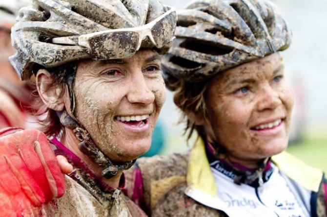 Yolandi de Villiers (left) and Yolande Speedy, photographed at the finish of the final muddy stage in 2012, will be back to defend their women's title against a very strong field at the 2013 Cape Pioneer Trek