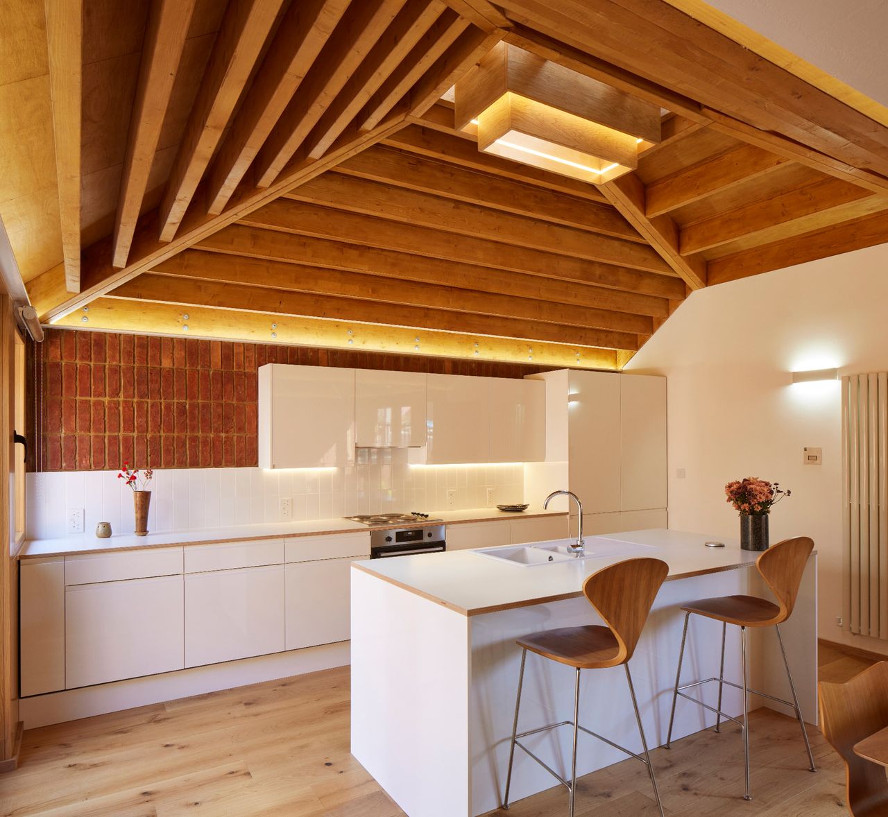 A small kitchen in a single storey home with vaulted timber ceiling