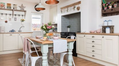 kitchen with dining area with dining set and cream colour cabinet