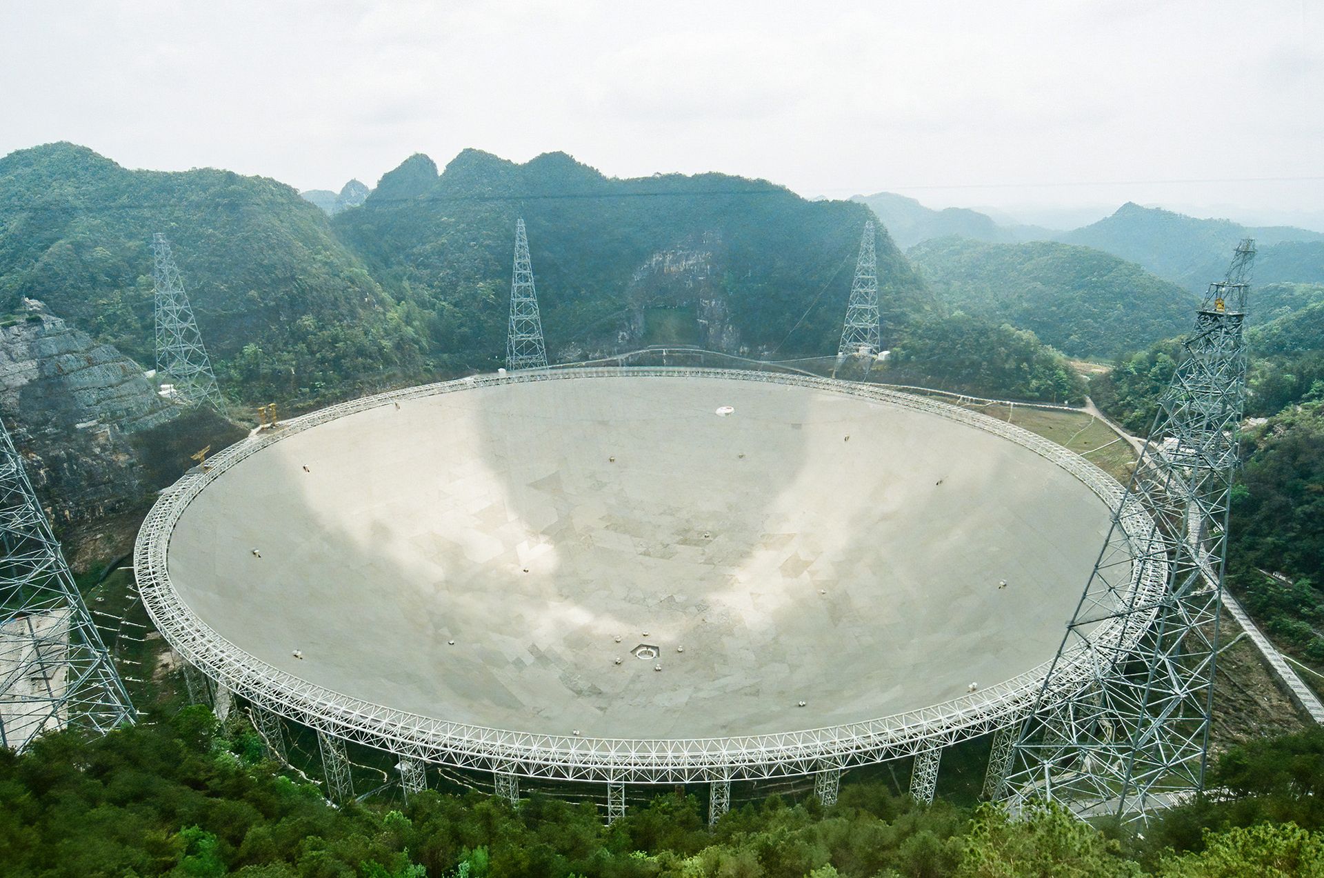 A large circular disk is seen in the middle of a forrested region.