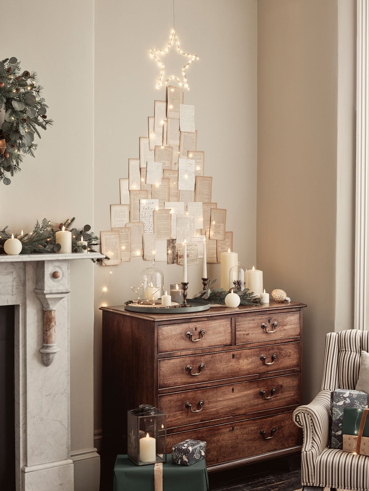 Old hymn sheets in Christmas tree form behind chest in living room