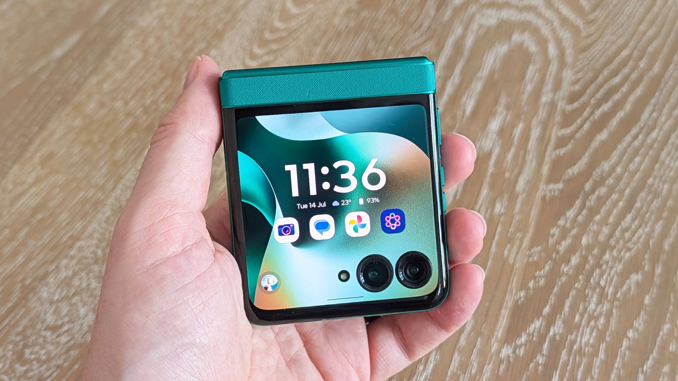 Motorola Razr 2026 in blue, being held in the hand