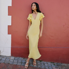 A model wearing a yellow Nobody's Child dress. 