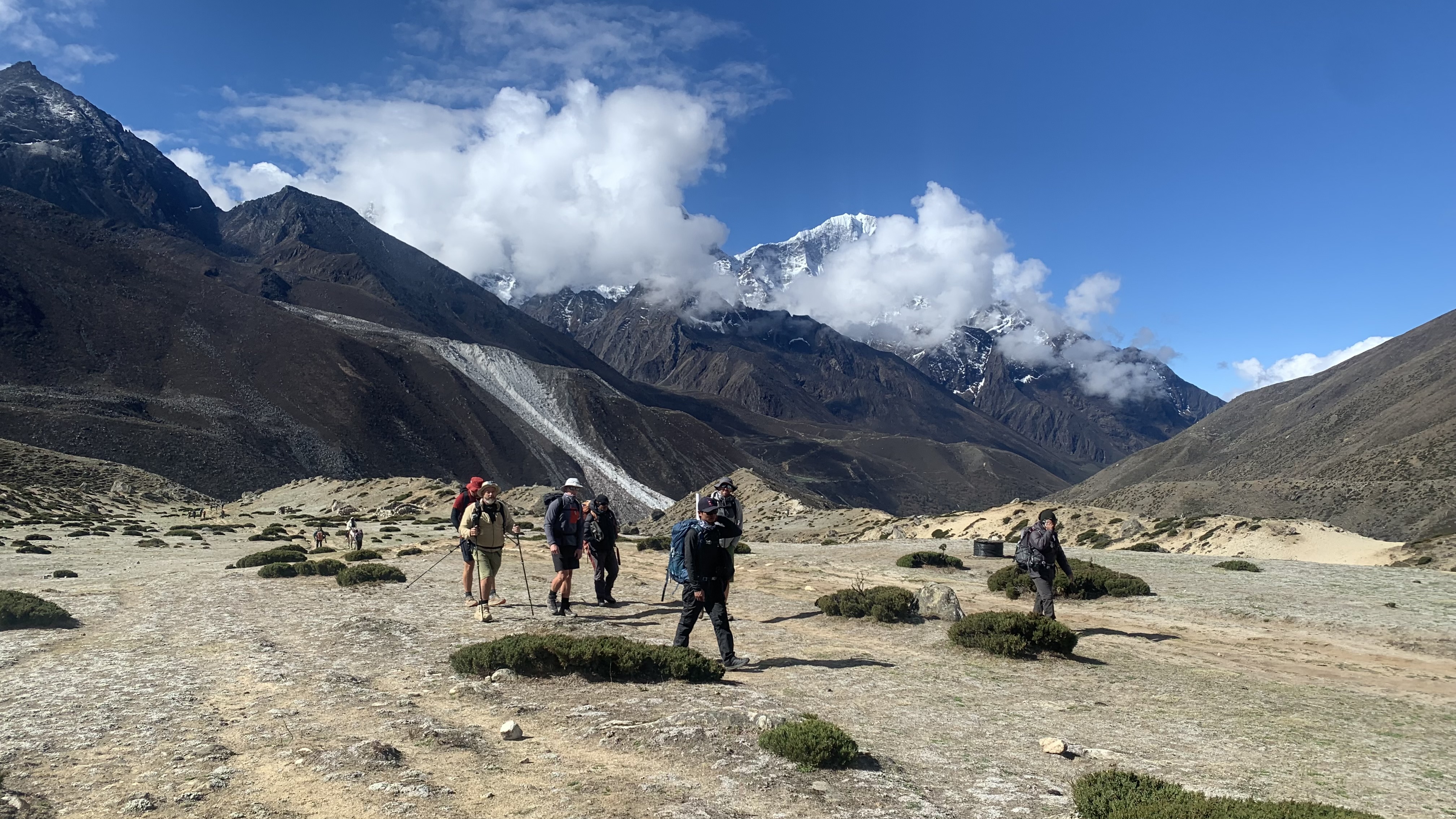 Men trekking across alpine desert in the Himalayas