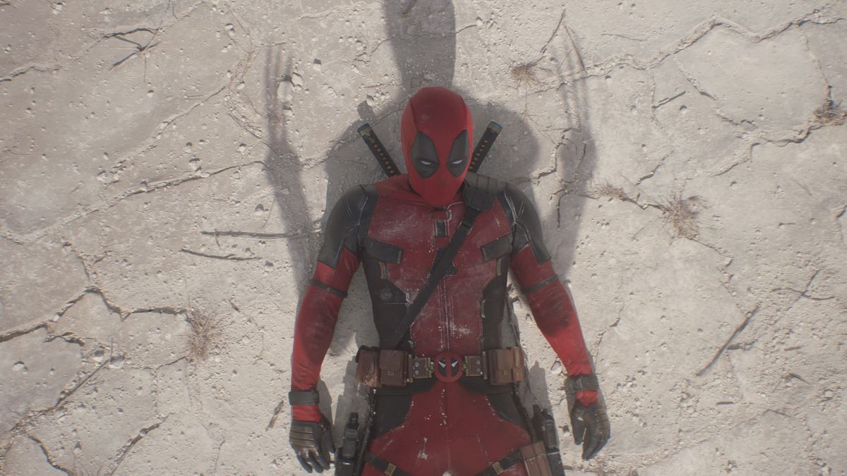 Deadpool laying on the ground with a shadow of Wolverine on top of him in Deadpool &amp; Wolverine