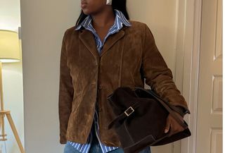 woman in suede jacket and bag