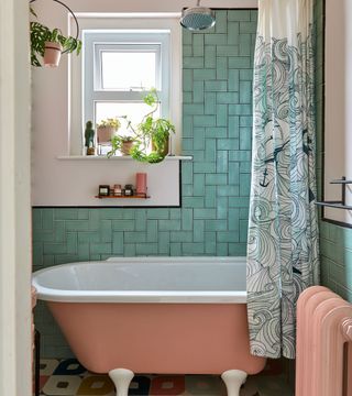 bathroom with pink bath and blue metro tiles