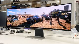 Samsung Odyssey OLED G9 monitor on white desk with Cyberpunk 2077 gameplay on screen