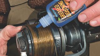 How to cast for carp - an angler prepping a reel for carp casting