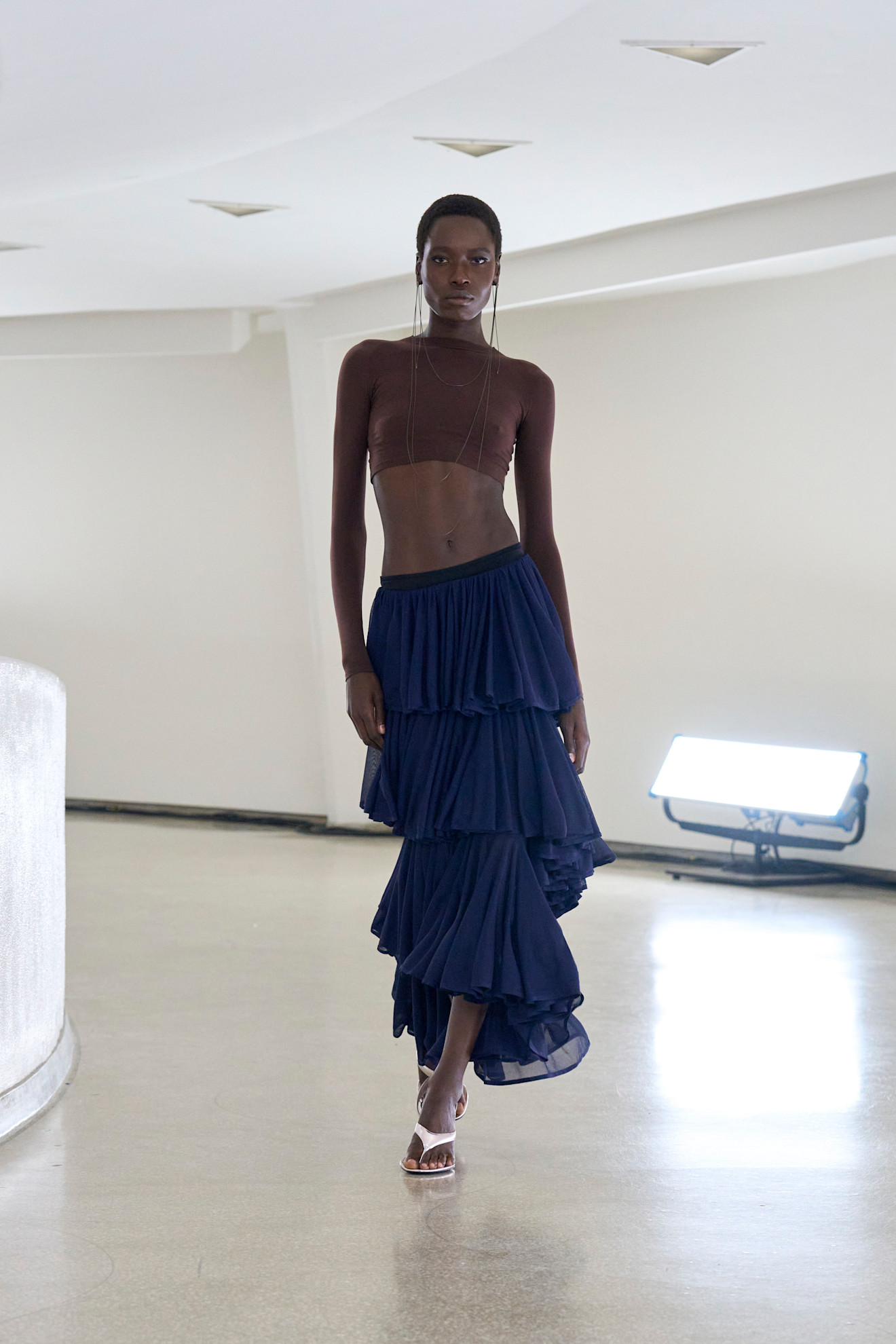 a woman wearing silver heeled thong sandals at Aläia Spring/Summer 2025 runway