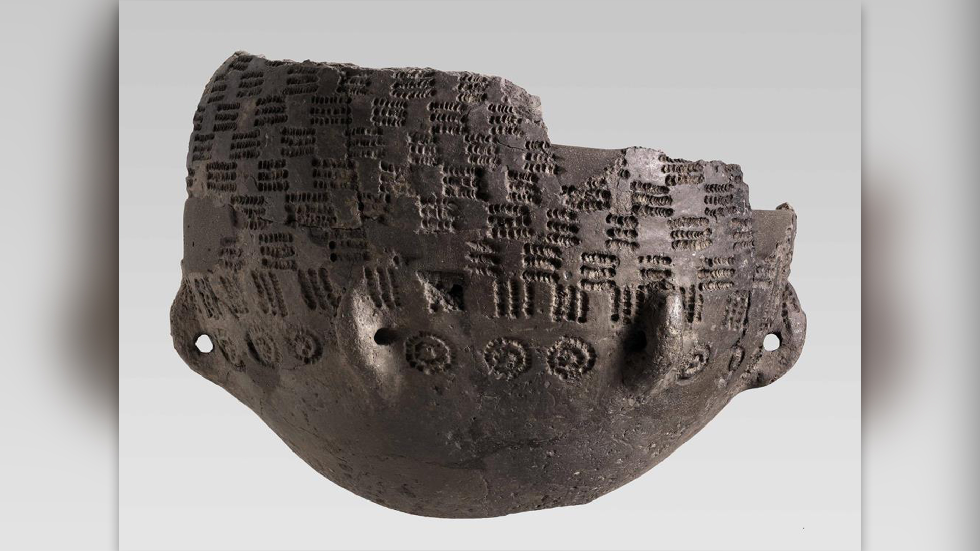 Reinstalled fragment of a patterned lug vase.